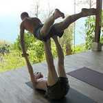Two yogis practice "acroyoga" at Anamaya Yoga retreat center in Montezuma, Costa Rica